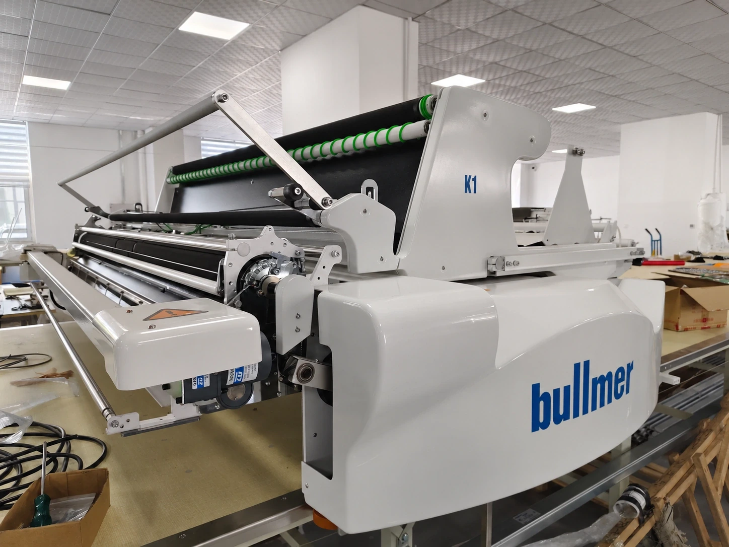 A fabric-spreading machine at a preparation table