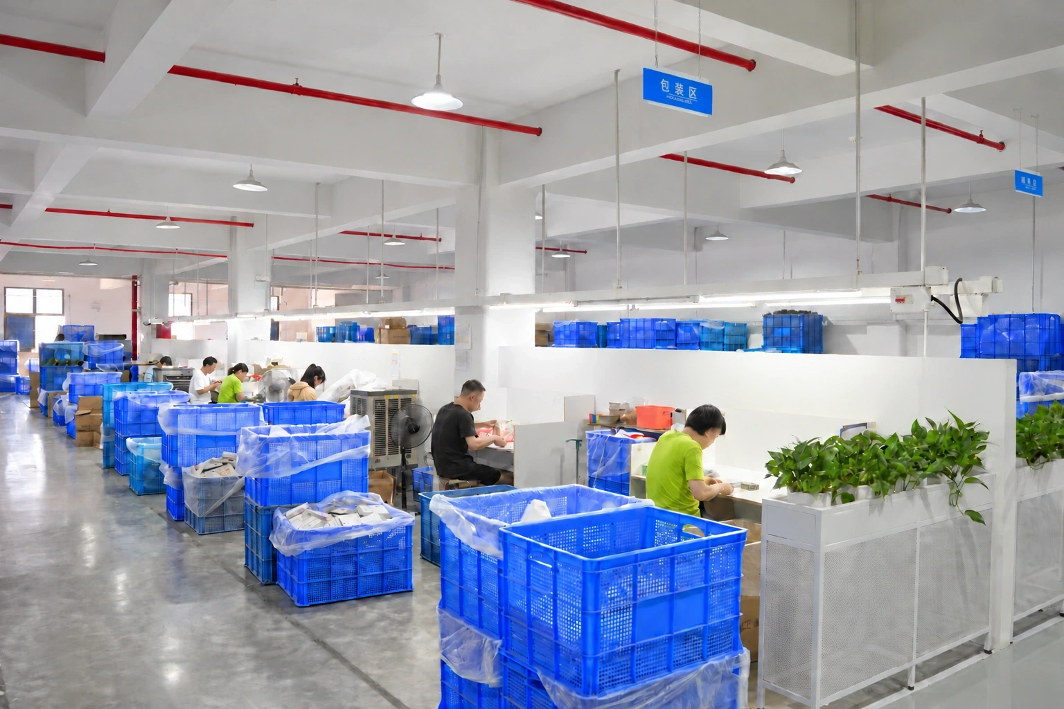 Workers preparing items at packing stations with blue sorting bins