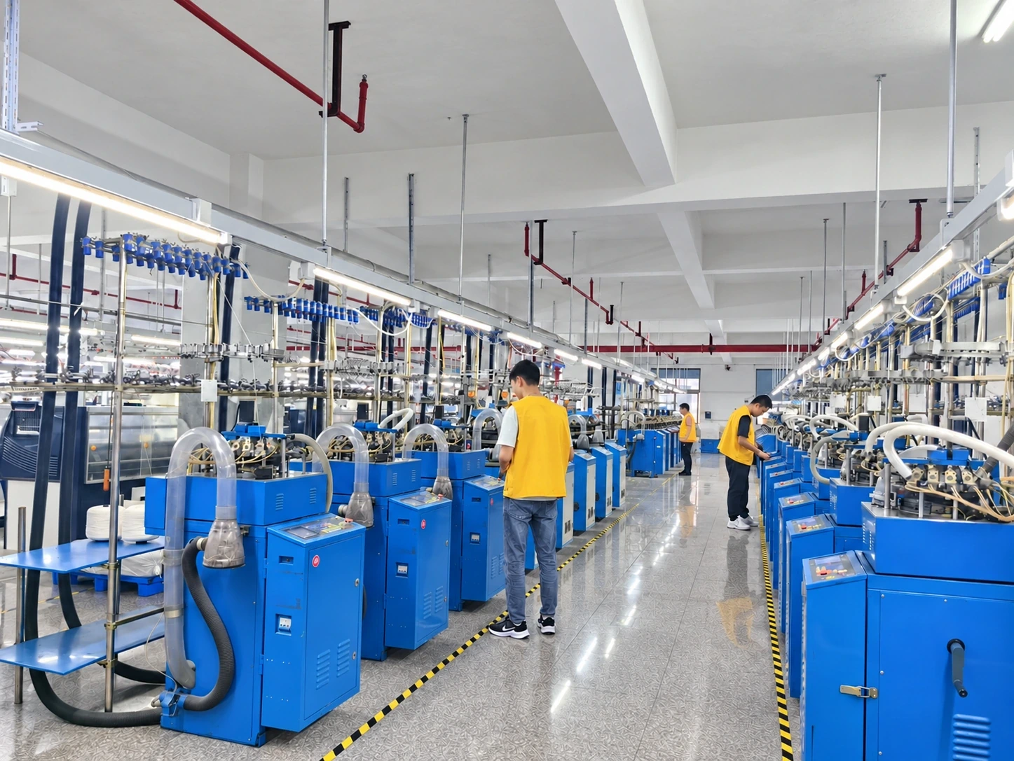 Operators working among textile knitting machines