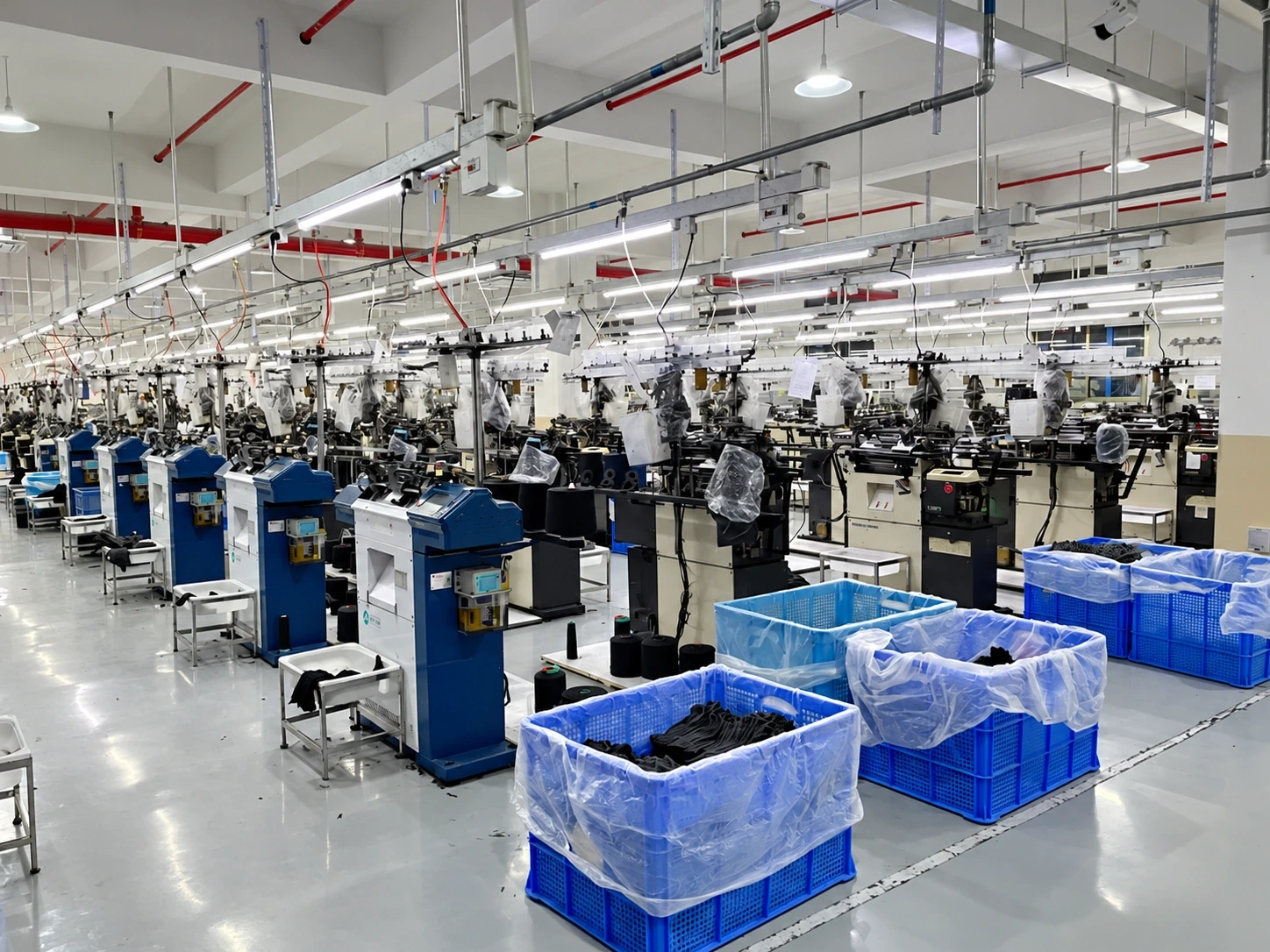 Textile knitting machines across a workshop floor
